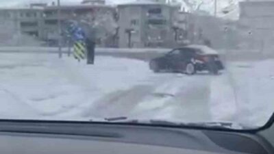 Bursa’da etkili olan kar yağışını fırsat bilen sürücü, otomobiliyle kavşakta