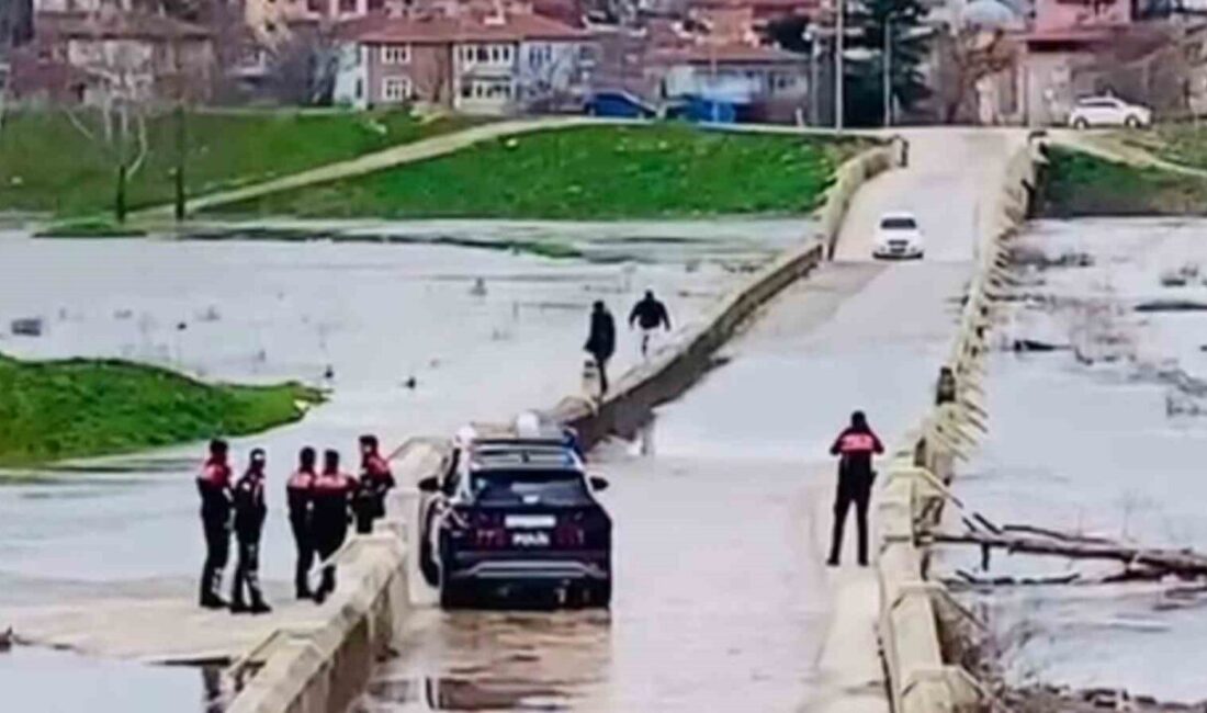 Edirne’de yağış sonrası suyla kaplanan Yalnız Göz Köprüsü’nde iki kişi,