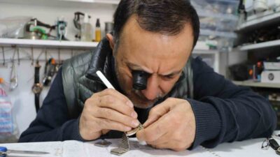 Eskişehir’de çıraklıktan yetişen saat tamircisi Harun Özden, saat alırken ve